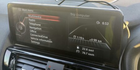 Factory iDrive interface shown on the larger Android screen