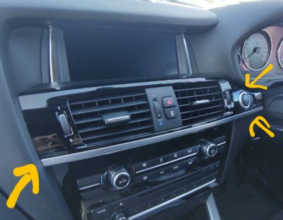 Prying point for the upper trim panel, marked with a yellow circle