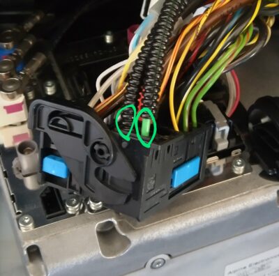 Two fiber-optic leads that must be repinned, marked with green circles