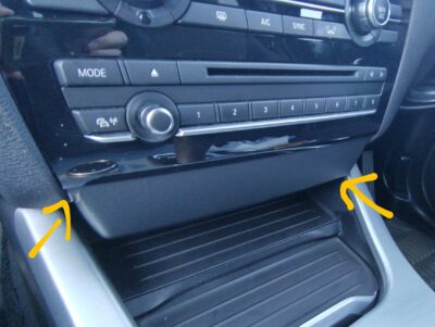 Prying off the lower black panel below the climate controls