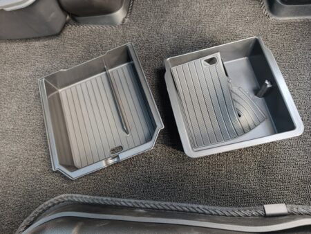 The two trays: one for the armrest, one for the front console