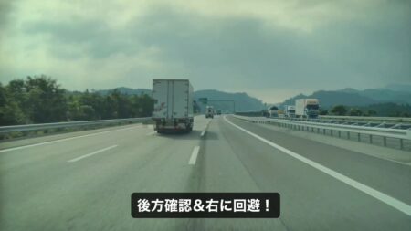 Dashcam frame of the Tesla Model YL moving right within the lane to avoid the debris