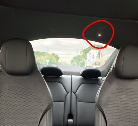 Looking up at the roof from the back seats. The red circle marks the faulty rear map light
