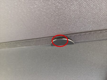 Clip pinched onto the headliner trim edge, circled in red