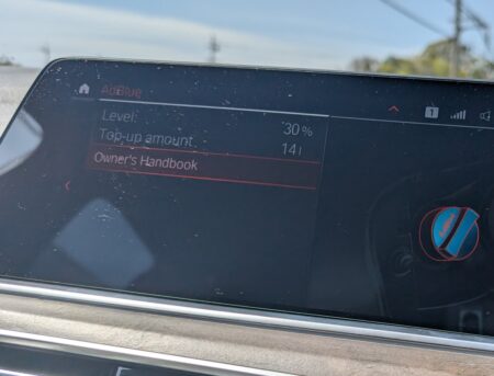 iDrive AdBlue screen showing Level 30 percent, top-up amount 14 litres