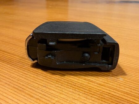 Back of the BMW key showing the cover release slot