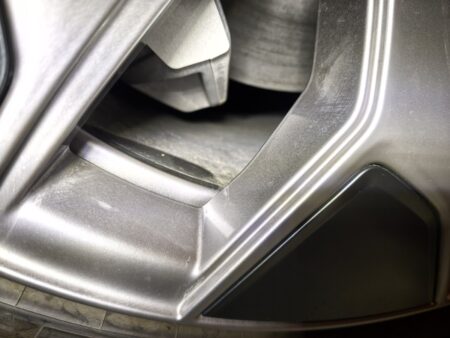 Top of the Model YL brake caliper seen through the wheel spokes