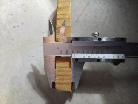 The wooden gauge measured with calipers at 13.5 mm