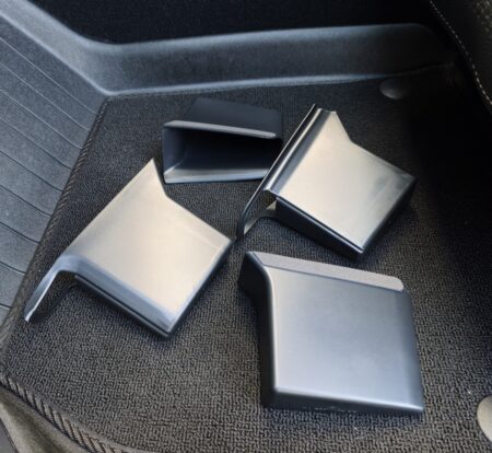 The four-piece Tesla Model YL door-handle storage box set, laid out on a floor mat