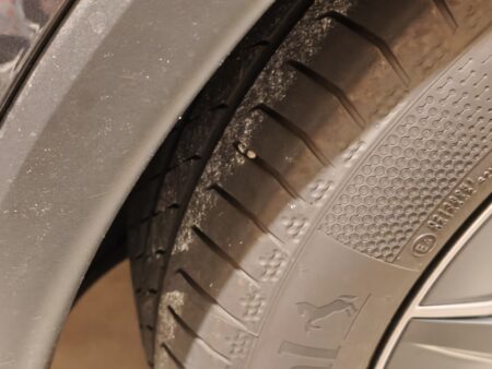 Small stone wedged deep in a tyre tread groove