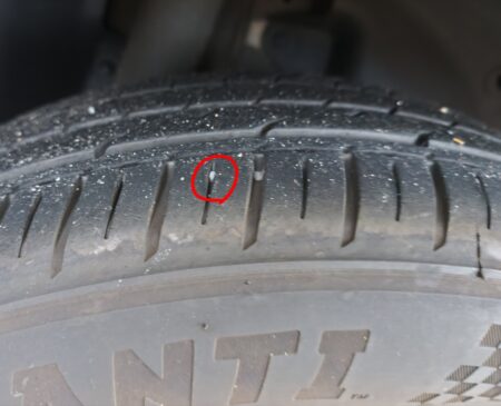 A stone pushed deep into the tread, marked with a red circle
