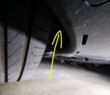 The gap behind the Model YL rear tyre where I put my phone to photograph the spring