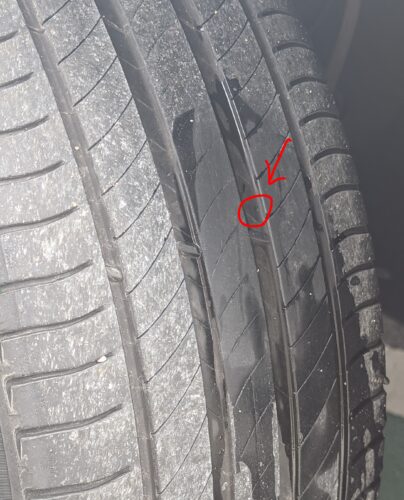 A red circle marking a tiny dot in the tread