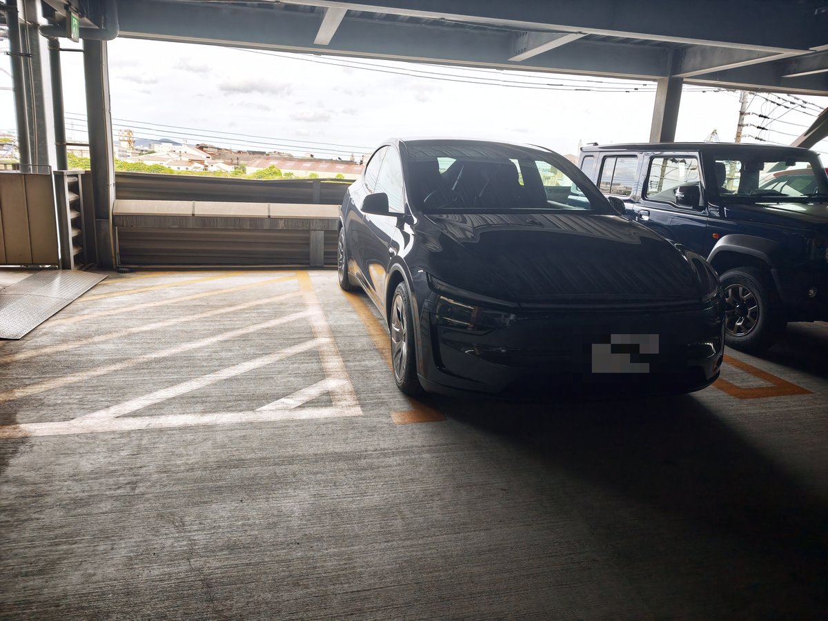 立体駐車場に停めたテスラ Model YL。ナンバープレートにはモザイクをかけている